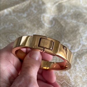 Michael Kors gold tone engraved hinged bangle